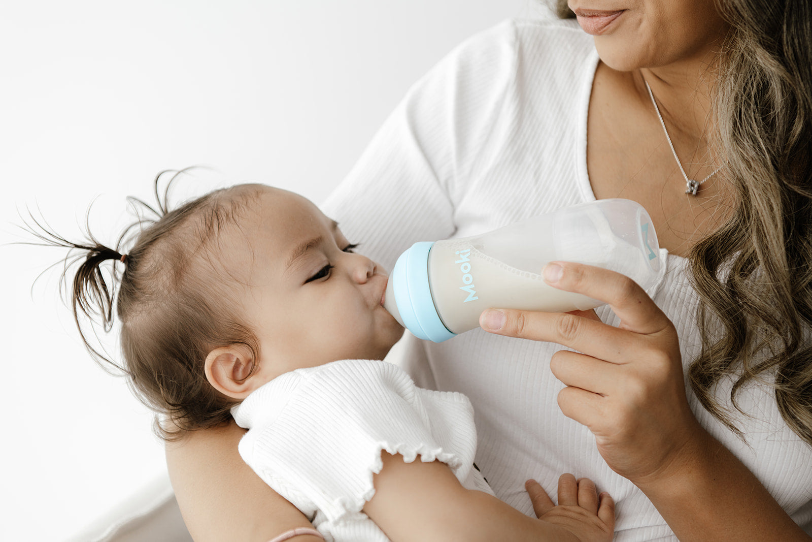 Baby taking in air while sales bottle feeding